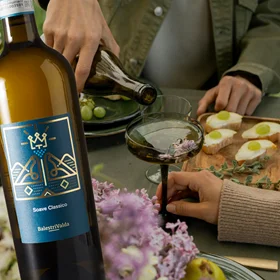 Valda Soave bottle person pouring white into a glass