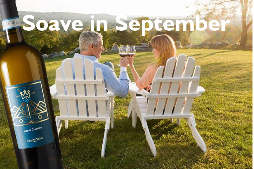 Balestri Valda Soave Classico with couple sitting in white chairs toasting