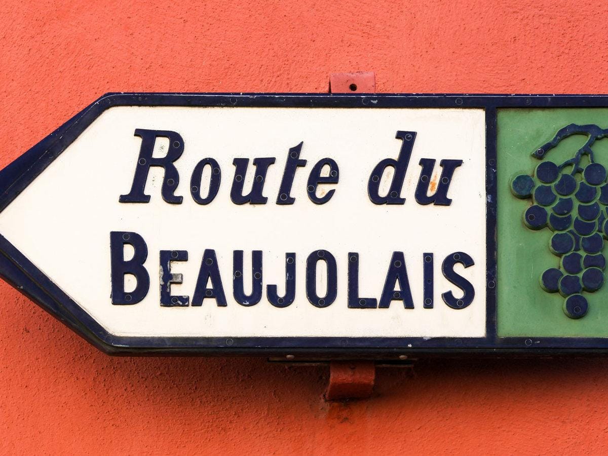A Route du Beaujolais road sign with a grape motif